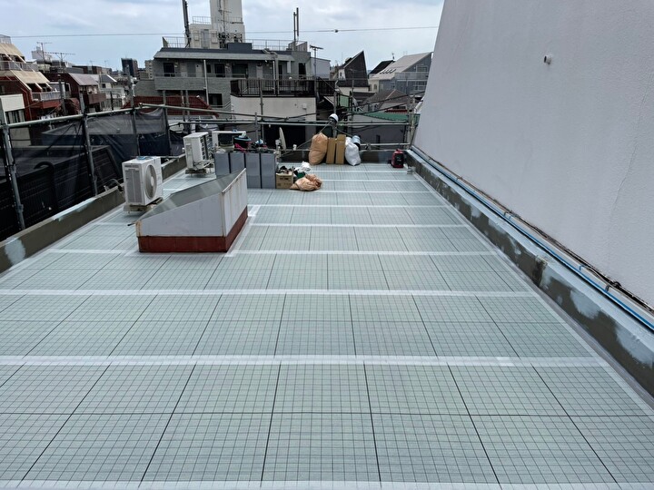 プライマー塗布後の通気緩衝シートの設置作業